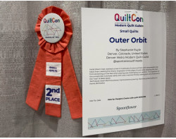 Outer Orbit by Stephanie Ruyle - Second Place Small Quilts Ribbon and Quiltcon 2024 Sign (Photo from auribuzz.com)