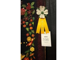 The Turning of the Wheel by Pamela Trantham - Third Place Small Wall Quilts Hand Quilted Ribbon at AQS QuiltWeek Paducah 2025