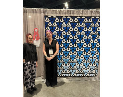 White Bubbles by Irina Timofeeva - Irina with her quilt at QuiltCon 2024 (Photo from The Modern Quilt Guild Instagram)