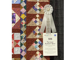The Lizzy Albright Quilt by Ricky Tims and Friends - Honorable Mention Group Quilts Ribbon and Sign (Photo by Ricky Tims from AQS QuiltWeek Paducah 2023)