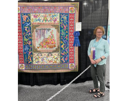 Pat Holly standing with her award-winning quilt, Joyful Japan (Photo by AQS Quiltweek)